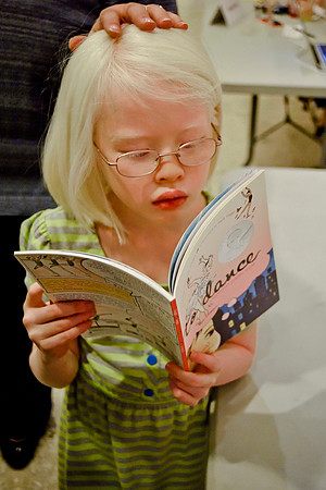 Albino child with caretaker behind her - White Plains Library, White Plains, NY, 2015