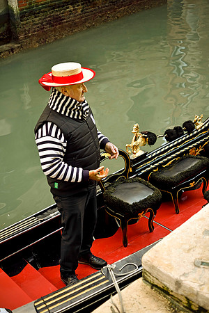 Gondolier on his gondola (boat) - Venice, Italy, 2017